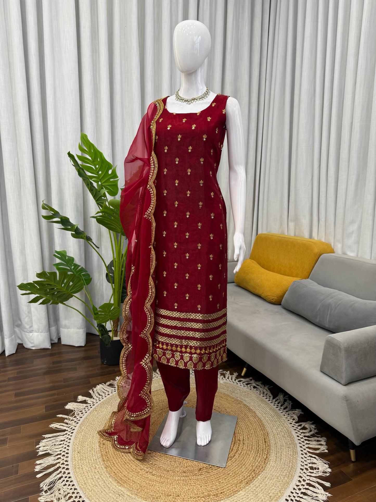 Maroon ethnic suit with gold embroidery, paired with matching dupatta, perfect for festivals and weddings.